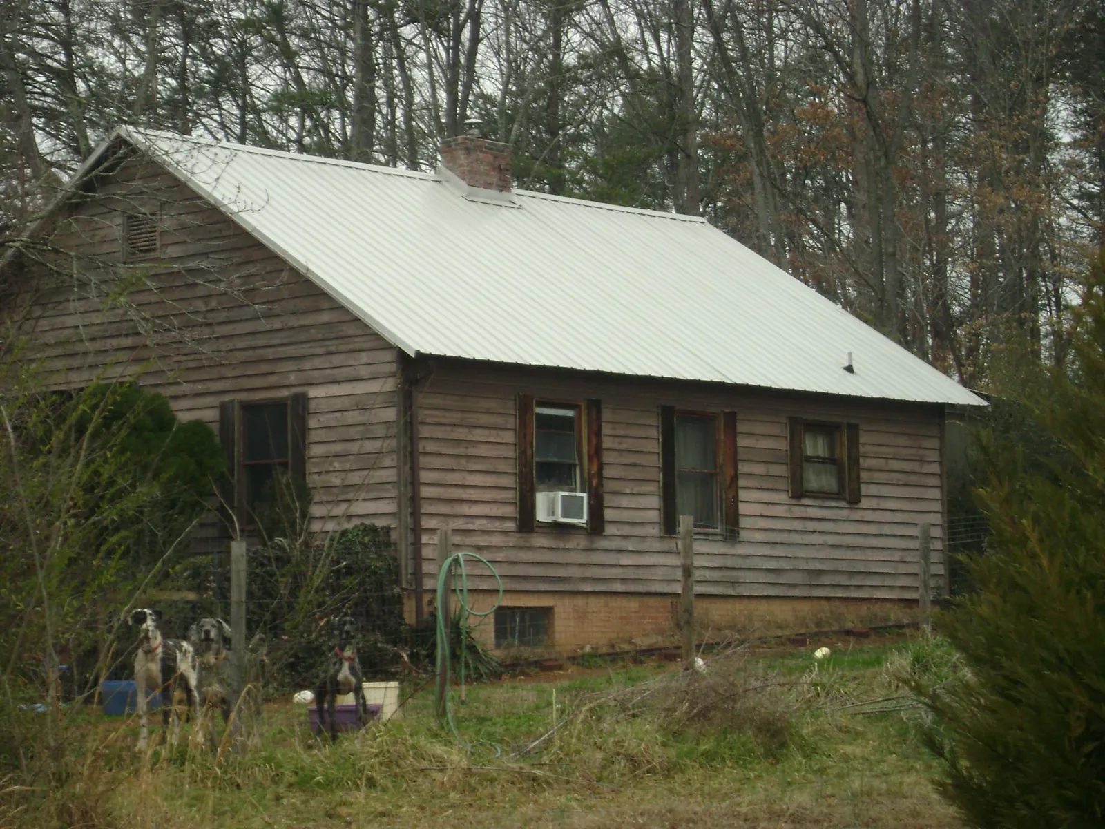 White metal roof on an old wood sided farmhouse, from a Metal Roof Installation job in Catawba